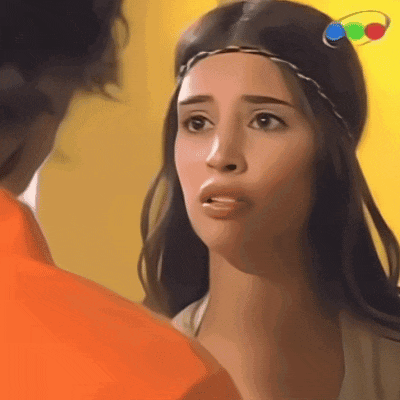 a woman with a headband on her head looks at a man