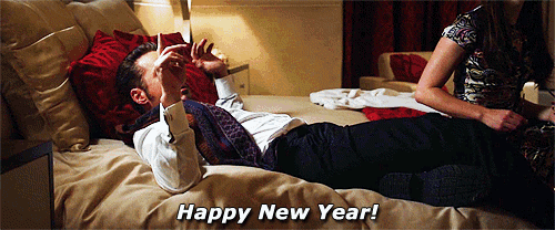 a man laying on a bed with the words happy new year written below him