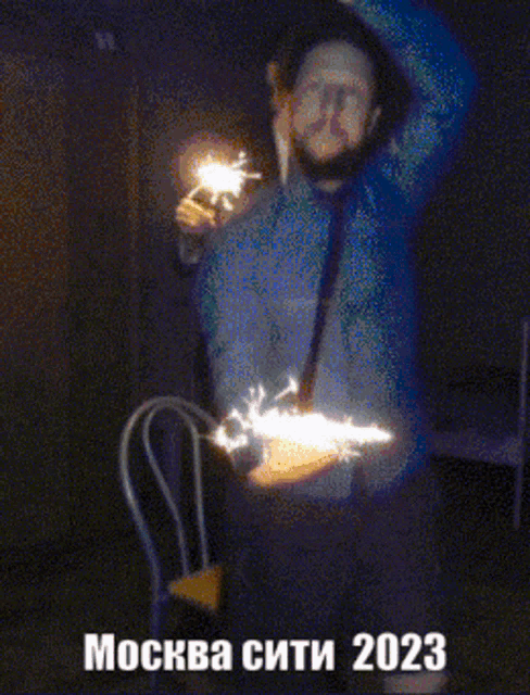 two men holding sparklers in front of a sign that says ' mockba city 2023 '