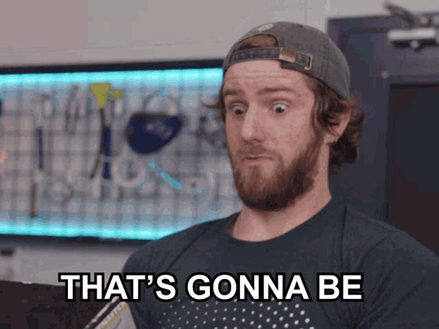 a man with a beard wearing a hat and a shirt that says " that 's gonna be "