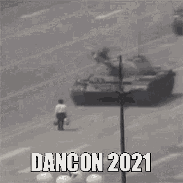 a man walking down a street with a tank in the background and the words dancon 2021