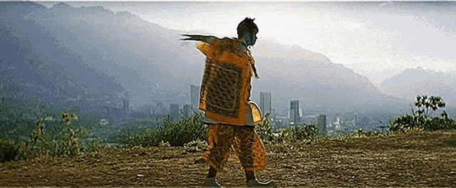 a person is standing on top of a dirt hill .