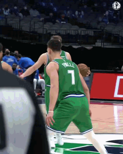 a basketball player wearing a green jersey with the number 7