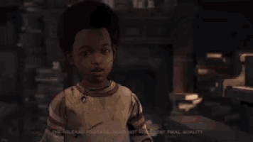 a young boy is standing in a dark room and looking at the camera .