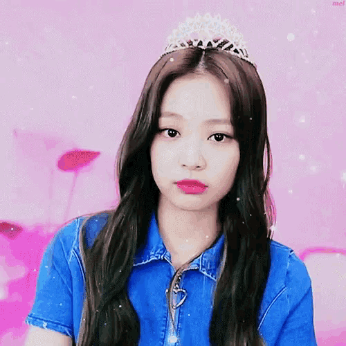 a girl wearing a tiara and a blue shirt
