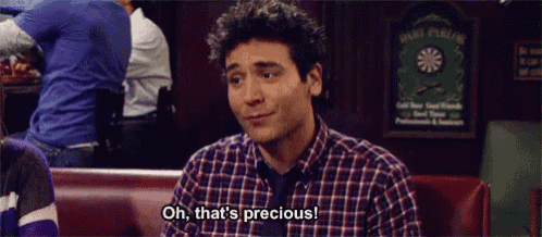 a man in a plaid shirt and tie is sitting in a booth and saying oh that 's precious .