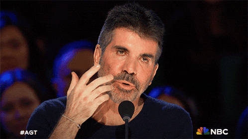 a man speaking into a microphone with the nbc logo on the bottom