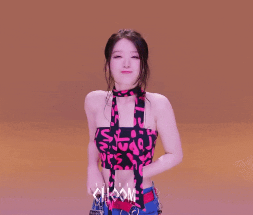 a woman wearing a choker and a halter top with the word choom on it