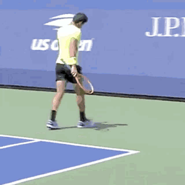 a man holding a tennis racquet on a tennis court