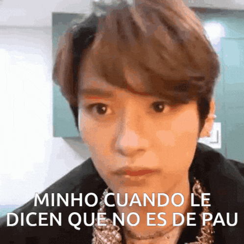 a close up of a person 's face with the words minho cuando le dicen que no es de pau written on the bottom