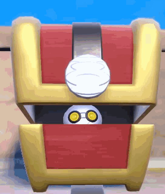 a red and gold treasure chest with a white object in it