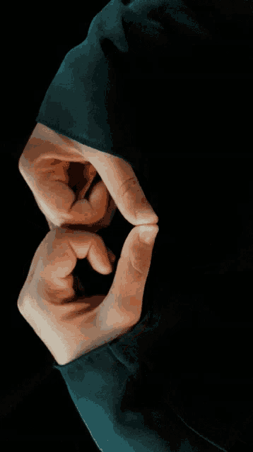 a close up of a person 's hands in a circle
