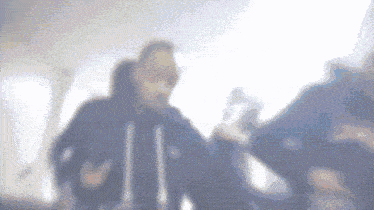 a blurry picture of a man in a black jacket