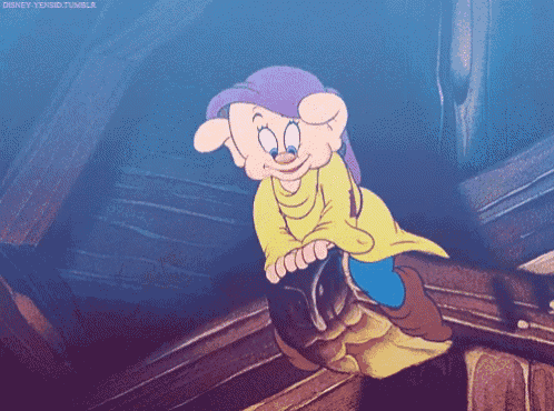 dopey from snow white and the seven dwarfs is wearing a yellow shirt and purple hat