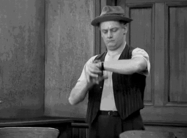 a black and white photo of a man in a hat