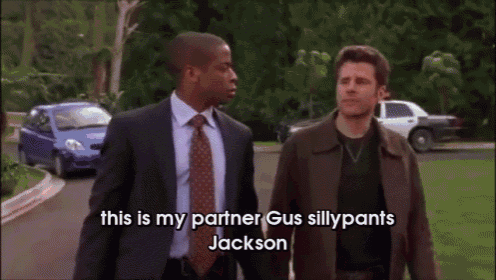 a man in a red shirt says this is my partner gus sillypants jackson in front of two other men