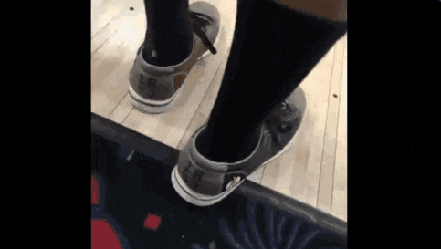 a person wearing a pair of bowling shoes with lr on them