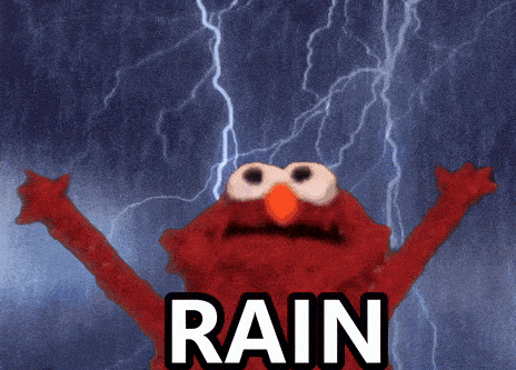 elmo from sesame street is standing in the rain