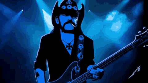 a man in a cowboy hat is playing a guitar