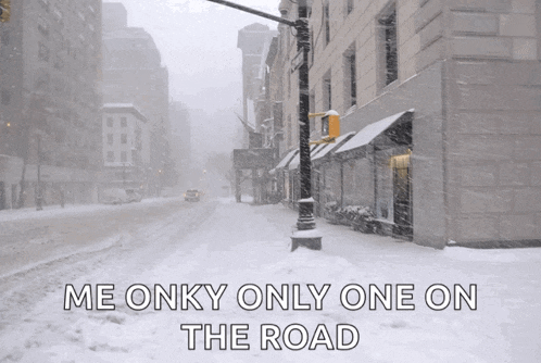 a snowy street with the words " me onky only one on the road "