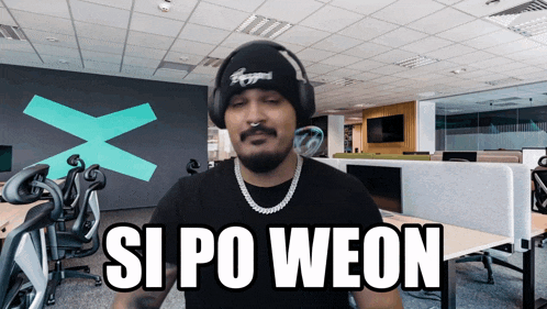 a man wearing headphones says si po weon in front of an office