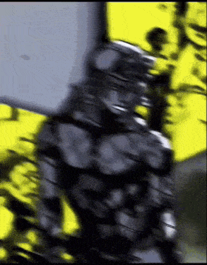 a blurry picture of a person standing in front of a yellow background