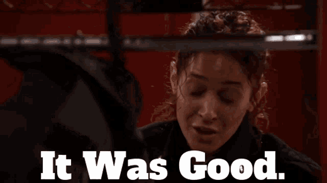 a woman says it was good in front of a red wall