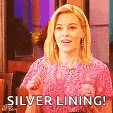 a woman in a pink dress is giving a thumbs up and says `` silver lining ! ''