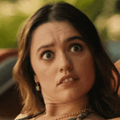 a close up of a woman 's face with her mouth open