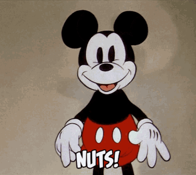 mickey mouse is holding nuts in his hands and smiling