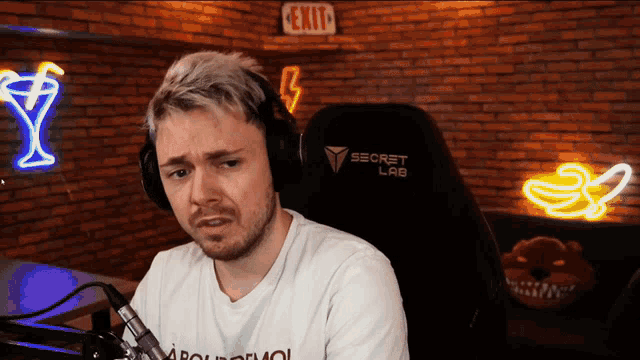 a man wearing headphones and a secret lab chair