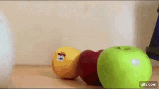 a bunch of different colored fruits are on a table