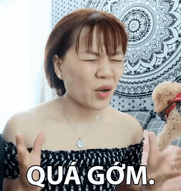 a woman making a funny face with qua gom written in white letters