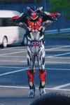 a person in a robot costume is standing in a parking lot with their arms outstretched .