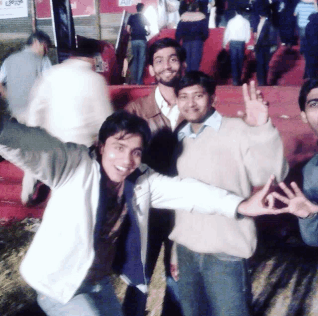 a group of young men are posing for a picture in front of a sign that says ' airtel '