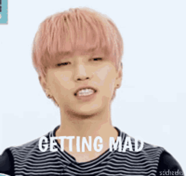 a young man with pink hair is wearing a striped shirt and is getting mad