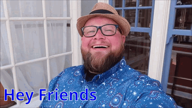 a man with a beard wearing glasses and a hat with the words hey friends below him