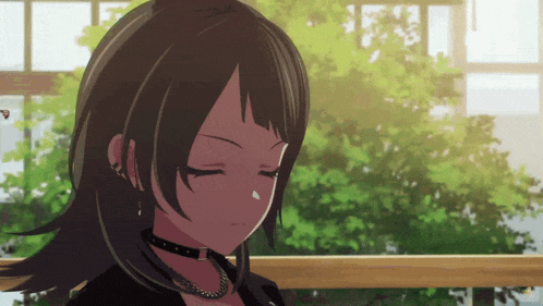 a girl with a choker on her neck is looking down