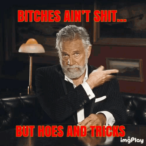 a man with a beard is sitting at a table with the caption bitches ain 't shit