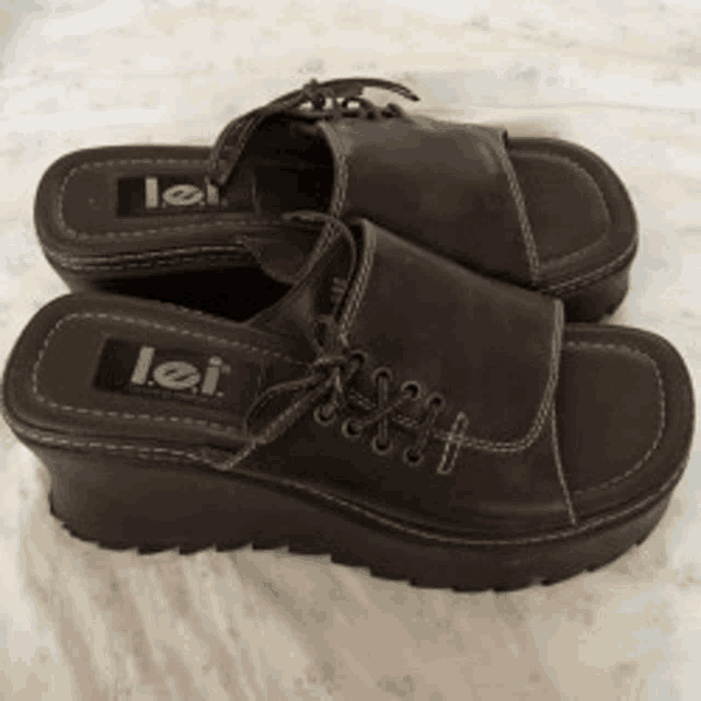 a pair of lei sandals are on a white surface