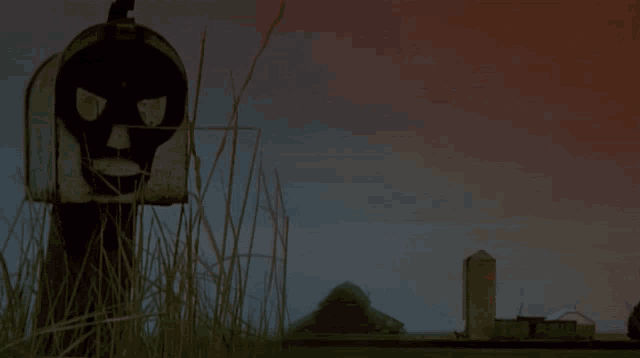 a mailbox with a face painted on it is in a field