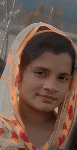 a woman with a scarf around her head is smiling