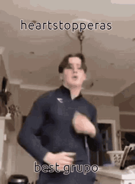 a young man is dancing in a living room with the words heartstopperas best grupo written on the bottom