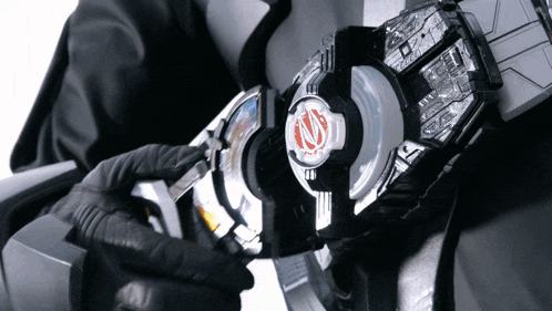 a close up of a person holding a device with a red n on it