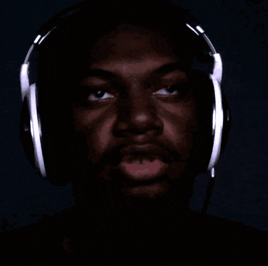 a man wearing headphones with his eyes closed and his mouth open