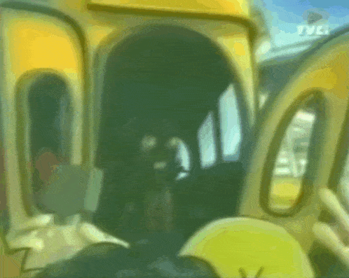 a blurry picture of a yellow bus with the tvc logo on the bottom right