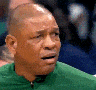 a man wearing a green shirt is crying