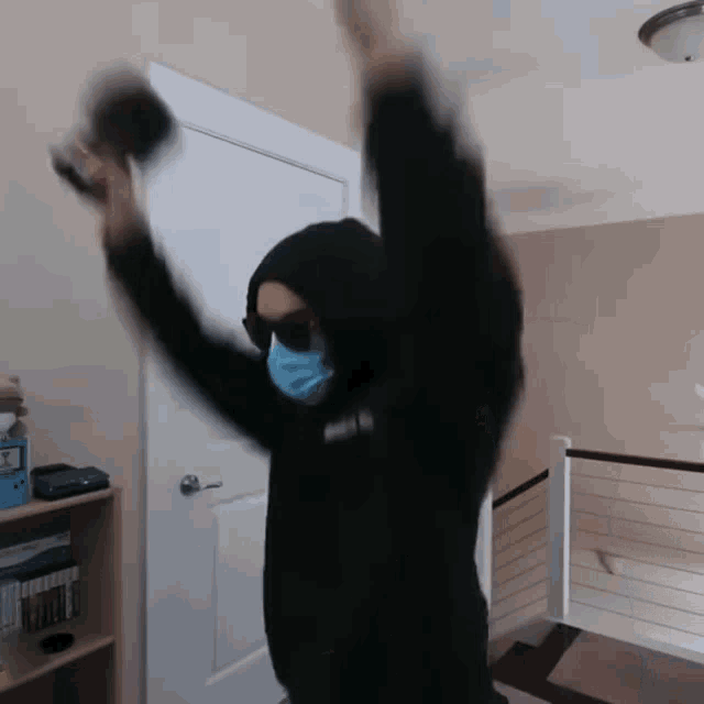 a man wearing a mask and sunglasses is standing in front of a door