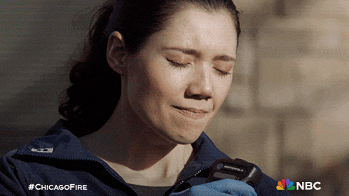 a woman is crying while holding a motorola device in her hand