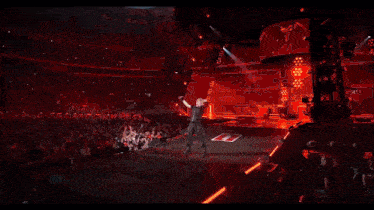a large crowd of people are watching a concert in a stadium with a sign that says ' a ' on it